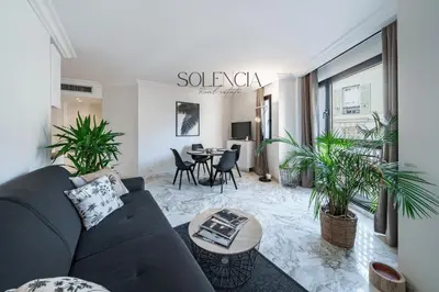 a living room with a couch and a table at 2 pièces rue d'Antibes - Climatisation in Cannes
