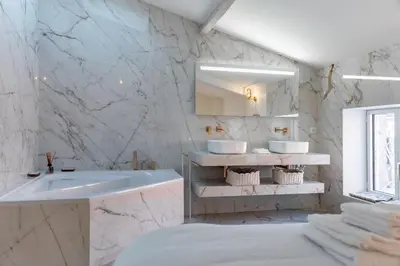 a white bathroom with a sink and two mirrors at 4 pièces sur la rue d'Antibes - Rénové et climatisé in Cannes