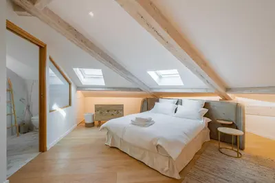 a bedroom with a large bed with skylights at 4 pièces sur la rue d'Antibes - Rénové et climatisé in Cannes