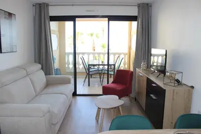 a living room with a couch and a table at Cap ô sud 1 in Cannes