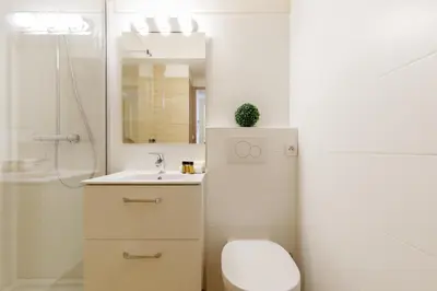 a bathroom with a toilet and a sink and a mirror at Colline Azur YourHostHelper in Cannes