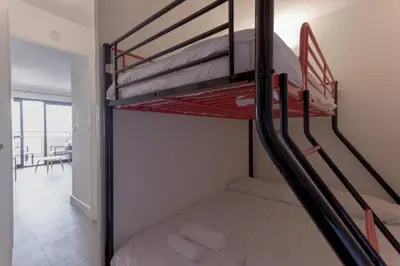 a bedroom with two bunk beds in a room at L'AZUR avec terrasse vue mer, piscine accessible et près des plages in Cannes