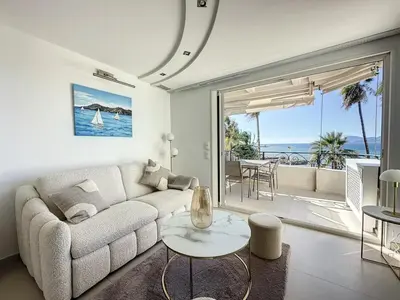a living room with a couch and a table at Modern 2-Bedroom Stunning Sea View on La Croisette in Cannes