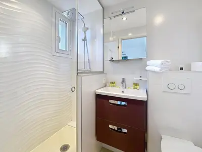 a bathroom with a shower and a sink and a toilet at Modern 2-Bedroom Stunning Sea View on La Croisette in Cannes