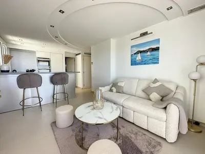 a living room with a couch and a table at Modern 2-Bedroom Stunning Sea View on La Croisette in Cannes