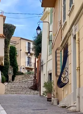 an empty street in a town with buildings at Le refuge du Suquet, quartier authentique de Cannes, vue mer in Cannes