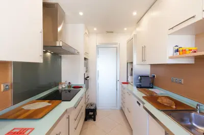 a kitchen with white cabinets and a sink at Sea View 95m Apartment with Large Terrace Cannes Croisette in Cannes