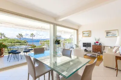 a dining room with a glass table and a view of the ocean at Sea View 95m Apartment with Large Terrace Cannes Croisette in Cannes
