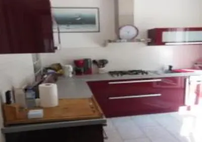 a kitchen with purple cabinets and a counter top at En ville un coin de campagne in Le Cannet