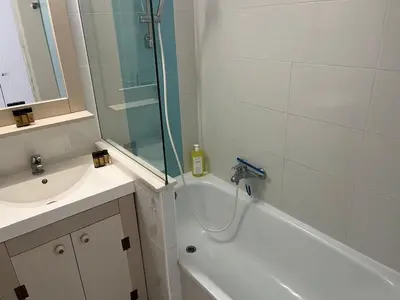 a bathroom with a shower and a sink and a tub at Sun and Sea in Cannes