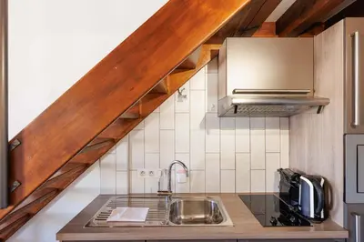a kitchen with a sink and a counter top at Residence Aout 41 in Cannes