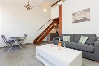 a living room with a couch and a table at Residence Aout 41 in Cannes