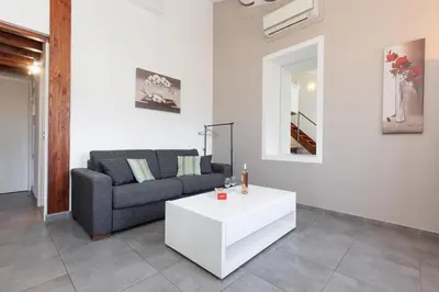 a living room with a couch and a table at Residence Aout 41 in Cannes