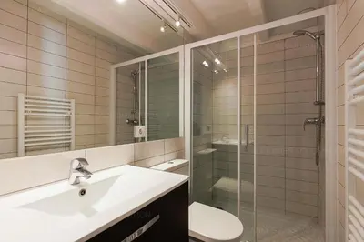 a bathroom with a sink and a shower and a toilet at Residence Aout 43 in Cannes