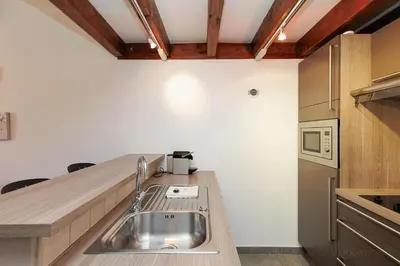 a kitchen with a sink and a counter top at Residence Aout 42 in Cannes
