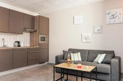 a living room with a couch and a table at Residence Aout 32 in Cannes