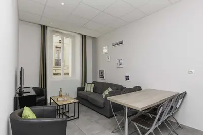 a living room with a couch and a table at Residence Aout 11 in Cannes