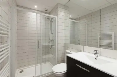 a bathroom with a shower toilet and a sink at Residence Aout 11 in Cannes