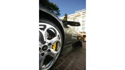 a black car is parked on a brick sidewalk at Residence Aout 21 in Cannes