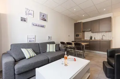 a living room with a couch and a table at Residence Aout 21 in Cannes