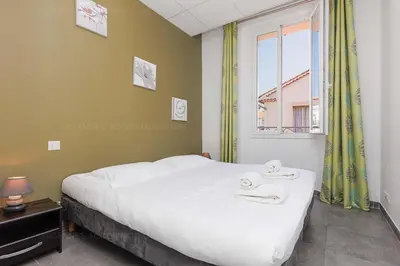 a bedroom with a bed with two towels on it at Residence Aout 31 in Cannes