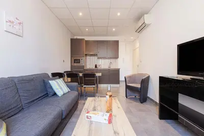 a living room with a couch and a table at Residence Aout 31 in Cannes