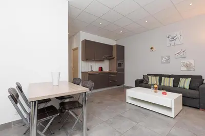 a living room with a table and a couch at Residence Aout 12 in Cannes