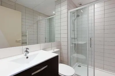 a bathroom with a toilet and a sink and a shower at Residence Aout 12 in Cannes