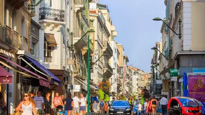 a crowd of people walking down a busy city street at Residence Aout 22 in Cannes