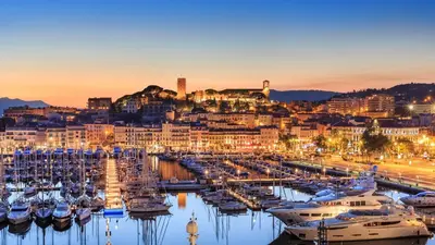 a group of boats docked in a marina at night at Residence Aout 22 in Cannes
