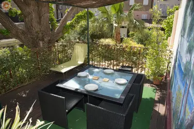 a black table and chairs with food on it at ALC - A523 - 4 min Palais and Beaches in Cannes