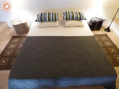 a bedroom with a large bed with two pillows at ALC - A523 - 4 min Palais and Beaches in Cannes