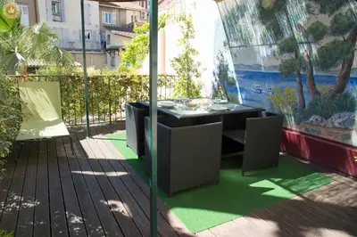 a patio with a table and chairs on a deck at ALC - A523 - 4 min Palais and Beaches in Cannes