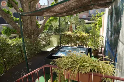 a patio with a hot tub and a tree at ALC - A523 - 4 min Palais and Beaches in Cannes