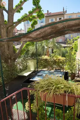 a garden with a hot tub under a tree at ALC - A523 - 4 min Palais and Beaches in Cannes