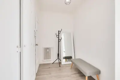 a living room with a bench and a mirror at Le Petit Fleury – Balcony, Calm in Cannes in Cannes