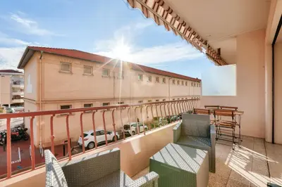 a balcony with chairs and a view of a building at Le Petit Fleury – Balcony, Calm in Cannes in Cannes