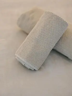 a close up of a tie on a bed at La Perle du Suquet, zone piétonne in Cannes