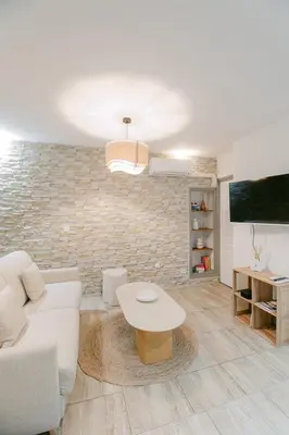 a living room with a white couch and a table at La Perle du Suquet, zone piétonne in Cannes