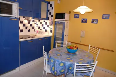 a kitchen with a table with a bowl of fruit on it at Cannes, La Palme d'Or in Cannes