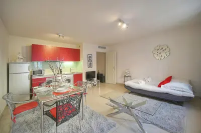 a kitchen and living room with a table and a bed at Immogroom - T2 - AC - Suquet in Cannes
