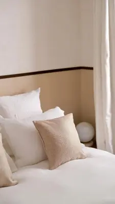 a white bed with white pillows and a headboard at Exceptional facing Palais Cannes 3 in Cannes