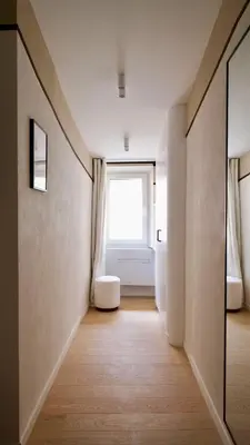a hallway with a window and a chair in a room at Exceptional facing Palais Cannes 3 in Cannes
