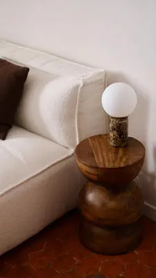 a wooden table with a lamp on it next to a couch at Exceptional facing Palais Cannes 3 in Cannes