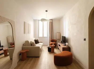 a living room with a couch and a chair at Exceptional facing Palais Cannes1 in Cannes