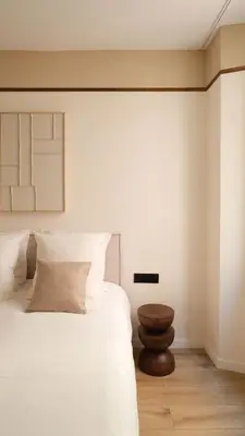 a bedroom with a white bed and a wooden stool at Exceptional facing Palais Cannes1 in Cannes