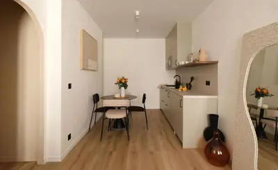 a small dining room with a table and a kitchen at Exceptional facing Palais Cannes1 in Cannes