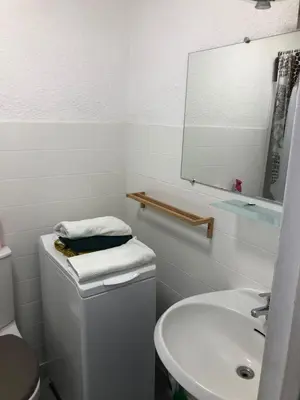a bathroom with a sink and a toilet and a mirror at Studio and breakfast in Cannes