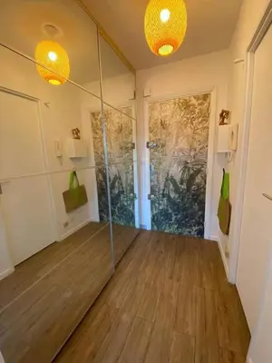 a room with a glass door and a wooden floor at Studio and breakfast in Cannes