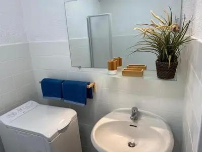 a bathroom with a sink and a toilet and a mirror at Studio and breakfast in Cannes